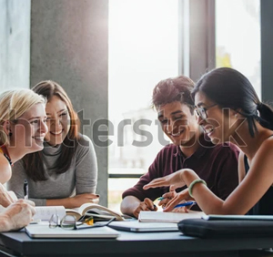 A group of friends collaborating on schoolwork in a bright setting.